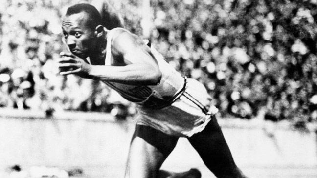 Jesse Owens breaks the 100m tape to win the first of his four gold medals at the Berlin Olympics.