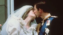 The newly-wed Prince and Princess of Wales share a kiss on the balcony of Buckingham Palace.