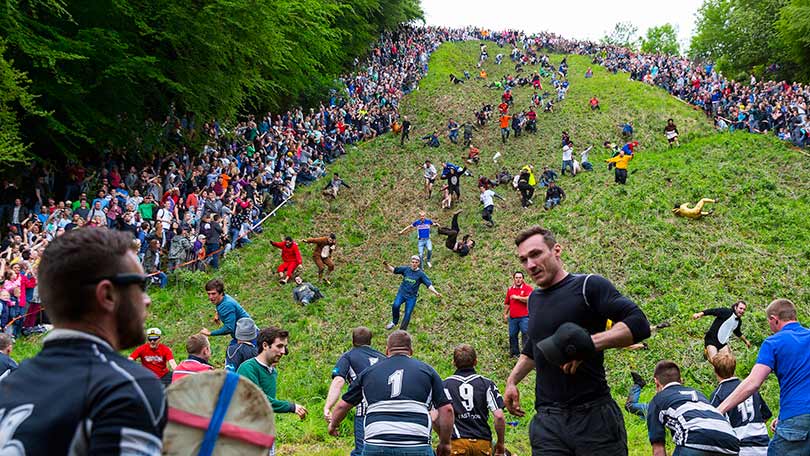 Thousands of people ventured to Cooper’s Hill in Gloucestershire on Bank Holiday Monday to watch the world famous cheese rolling competition.